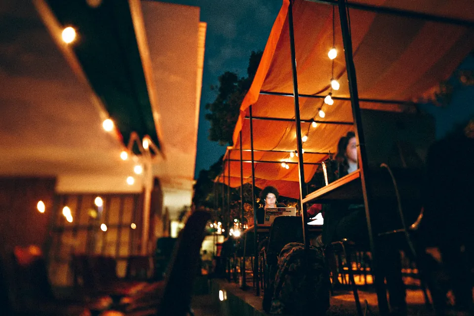 Restaurant patio glowing with string lights at night
